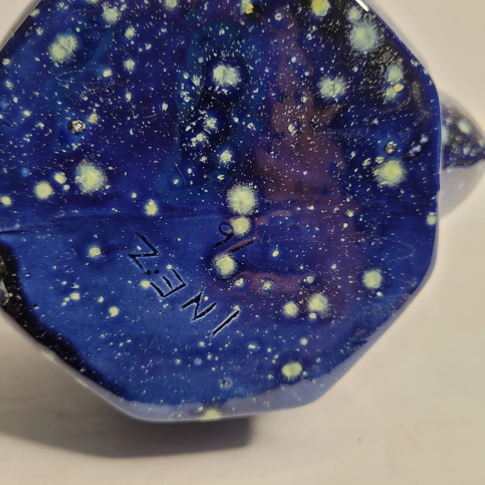 A blue and white speckled teapot. 271